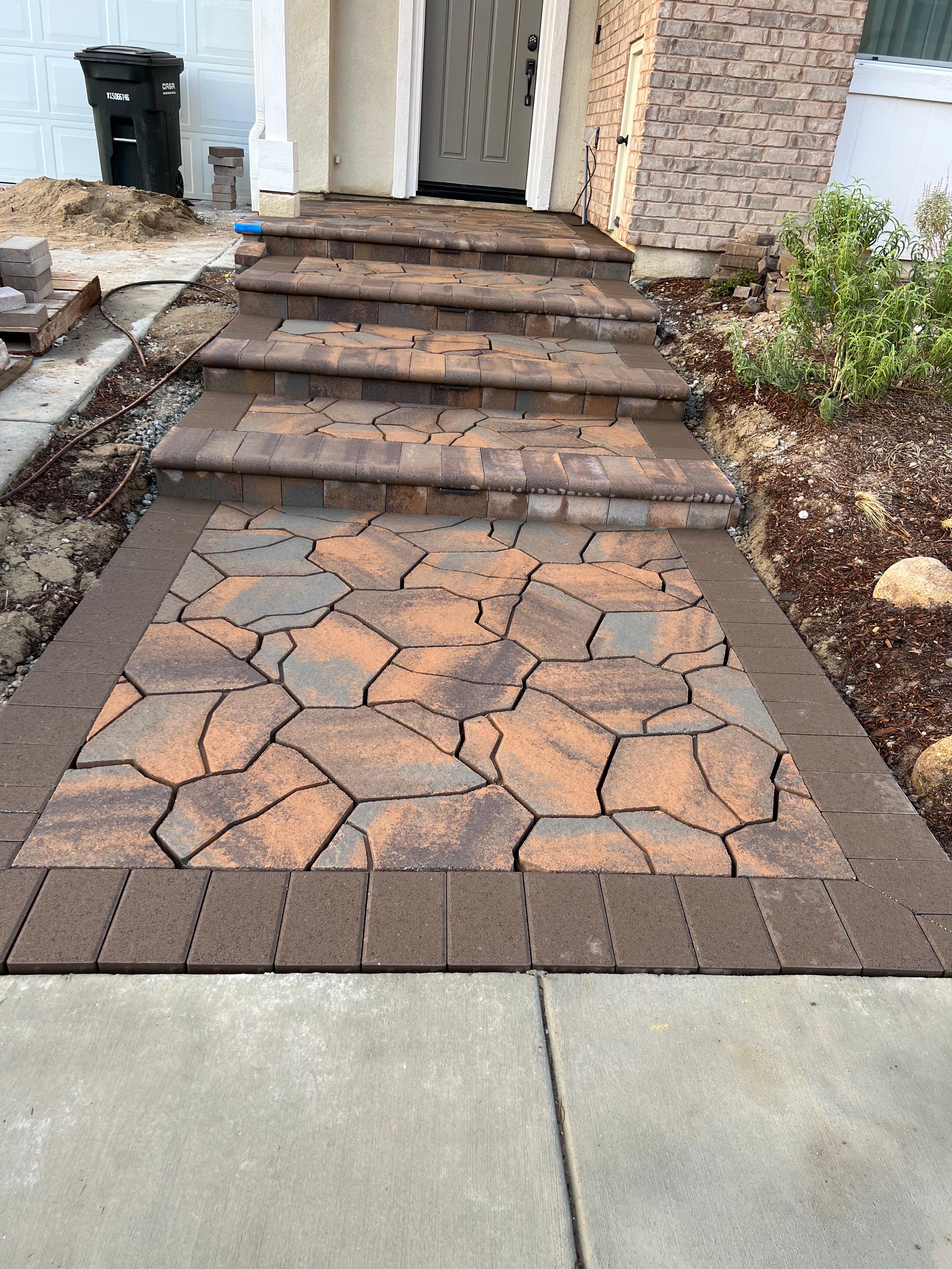 Decorative flagstone entryway with paver steps