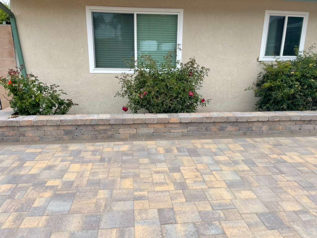 Paver patio with retaining wall and rose garden planter